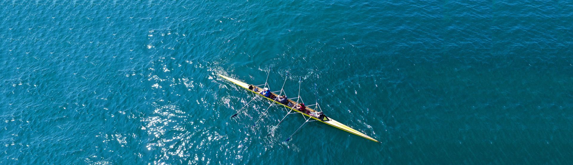 Ruder-Team auf dem Wasser in gleichmäßigem Takt
